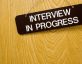 interview in progress sign hanging on door