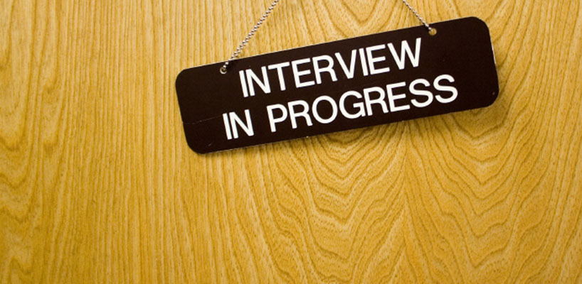 interview in progress sign hanging on door