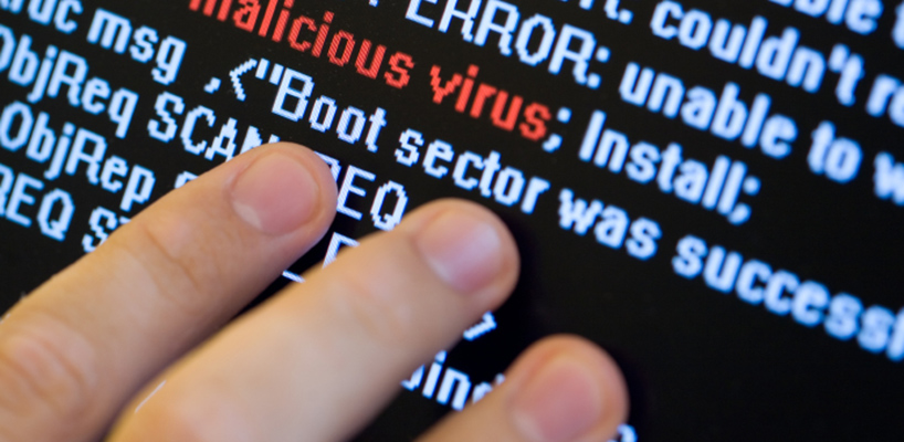 computer code with malicious virus hidden in code and fingers pointing
