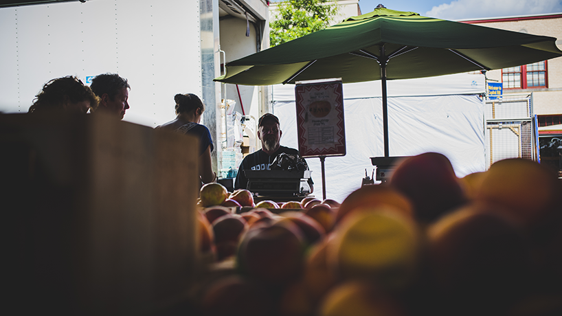 "A line quickly gathers as one of the Easter Market's local farm vendor lowers his prices at the close of business for the day. Many Capitol Hill residents fulfill much of their weekly fresh produce and grocery shopping solely from this neighborhood-Market-turned-tourist-attraction."