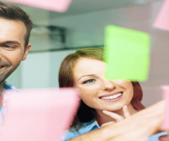 stock photo of women and man looking at sticky notes