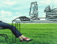 stock photo of woman sitting at drawn desk in grass