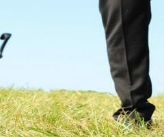 stock photo of man walking away from office chair in grass