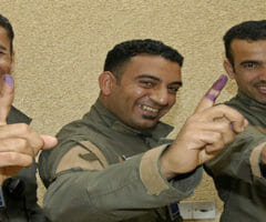 Iraqi police with ink-stained fingers after voting