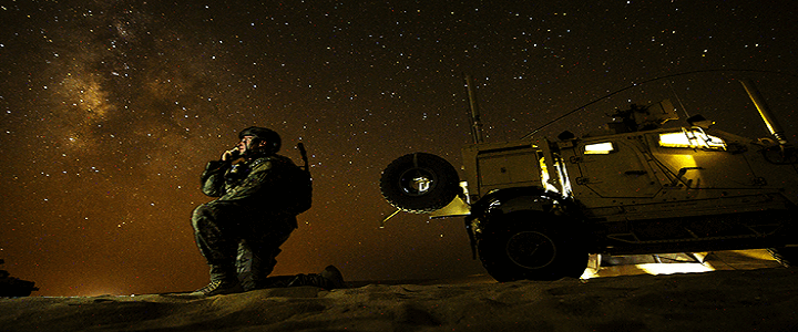 Man on hill with stars in background