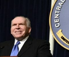 John Brennan standing at a podium in front of CIA seal