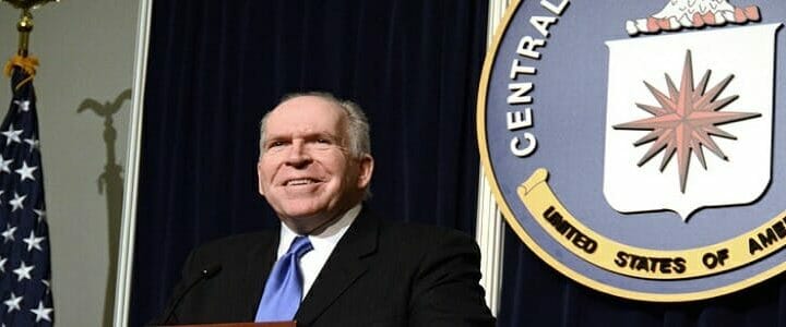 John Brennan standing at a podium in front of CIA seal