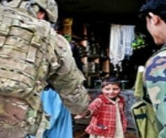 afghan boy shakes hands with paratrooper