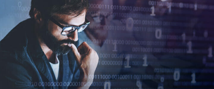 stock photo of man looking at screen with code overlaid