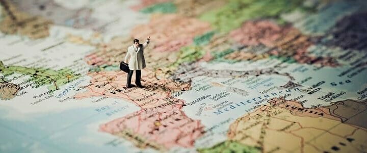 stock photo of small man figure on map of Spain