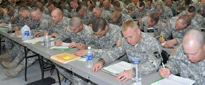 men in uniform in classroom taking test