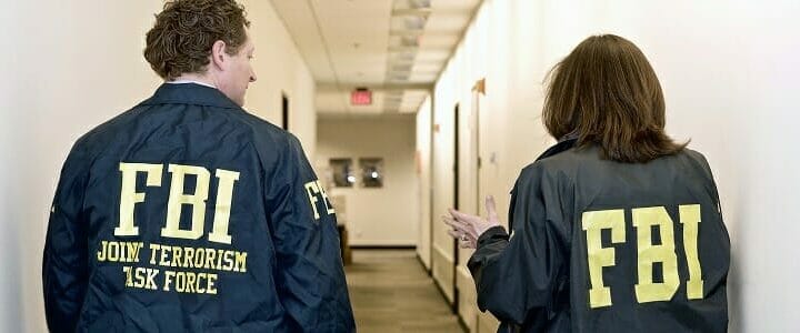 two fbi agents walk down hallway at washington field office