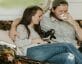 stock photo of man and woman on couch with dog