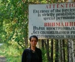 Documentarian Samira Goetschel in front of a sign in Ozersk