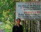 Documentarian Samira Goetschel in front of a sign in Ozersk