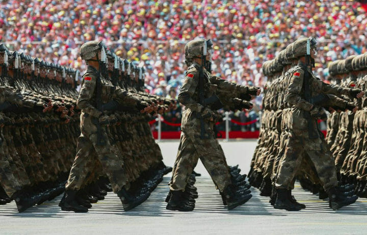 Chinese military personnel marching in street