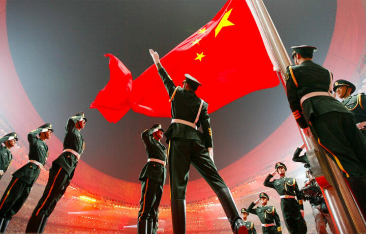 Chinese military personnel saluting Chinese flag