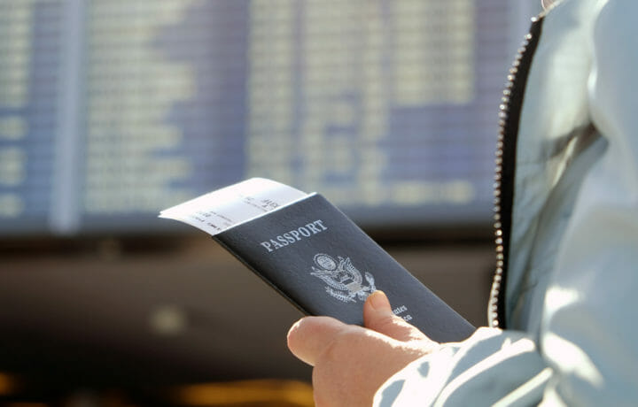Man holding passport and plane tickets are airport