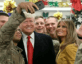 Military personnel taking selfie with President Trump and First Lady Melania Trump