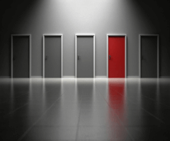 Stock photo of gray doors with one red door