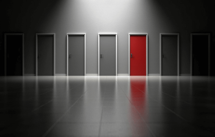Stock photo of gray doors with one red door