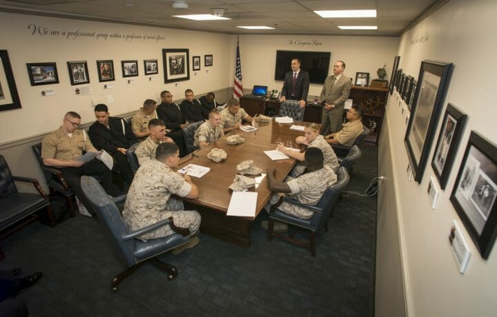 Military personnel meeting at conference room table