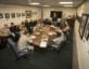 Military personnel meeting at conference room table