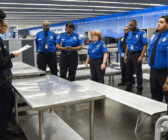 TSA employees in uniform at meeting at airport
