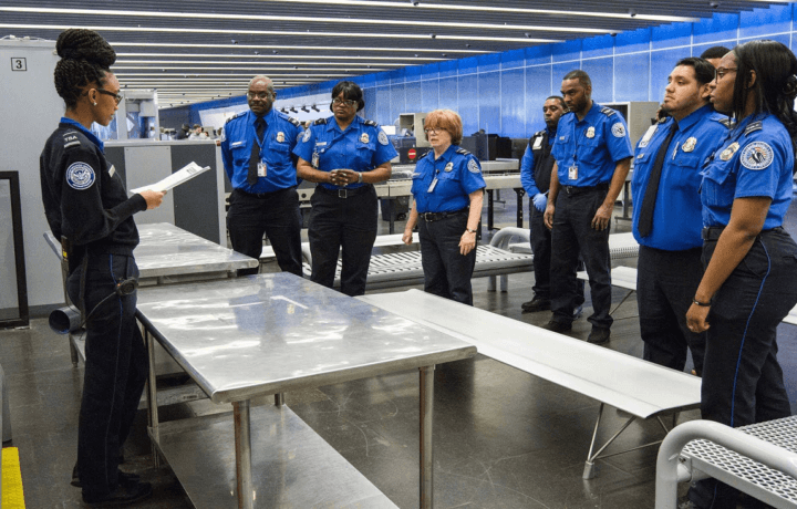 TSA employees in uniform at meeting at airport