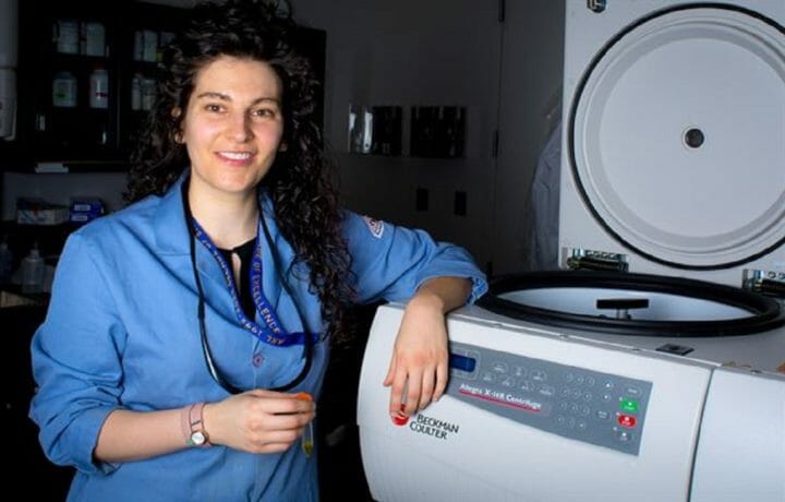 Woman posing in from of lab machine