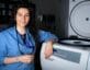 Woman posing in from of lab machine