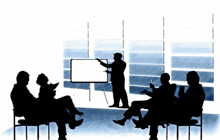 Illustration of people meeting and looking at whiteboard