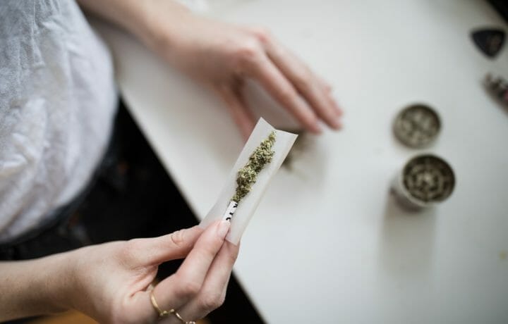 Woman rolling marijuana joint