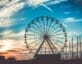Silhouette of ferris wheel at sunset