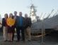 Group of people standing in front of USS Wisconsin battleship