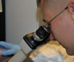 Man looking into microscope