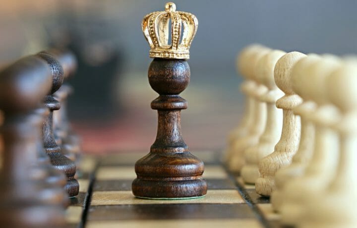 Photo of pawn chess piece wearing crown