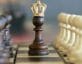Photo of pawn chess piece wearing crown