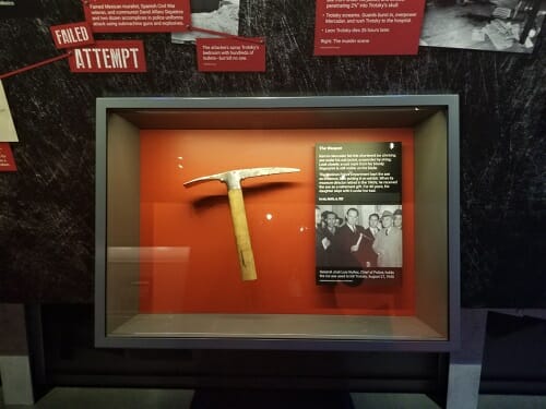ice pick with red background in a glass museum case Trotsky