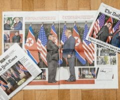 Photo of New York Times and Daily Telegraph newspapers on table showing President Trump and Kim Jong-un meeting