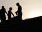 Silhouette of people on building