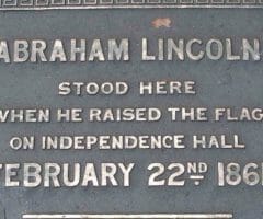 Plaque reading Abraham Lincoln stood here when he raised the flag on independence hall February 22, 1861