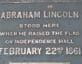 Plaque reading Abraham Lincoln stood here when he raised the flag on independence hall February 22, 1861