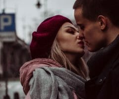 Photo of woman and man kissing on the street