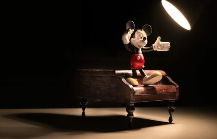 Mickey Mouse figurine dancing on tiny piano