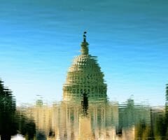 Reflection of capitol building in rippled water