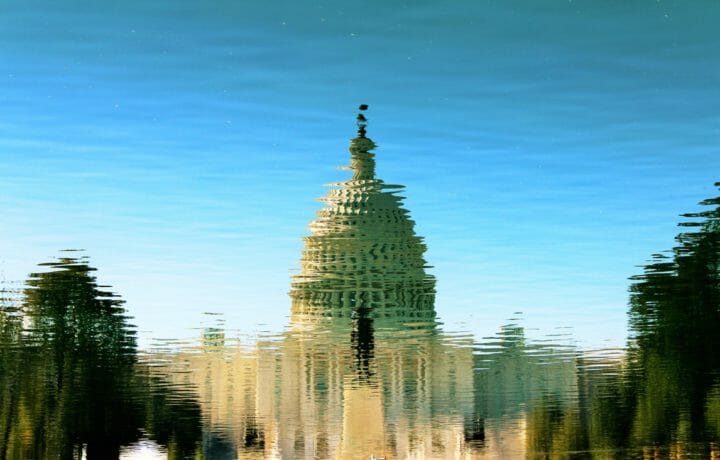 Reflection of capitol building in rippled water