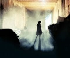 silhouette of female spy in the shadows with fog mysterious
