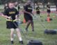 ACFT two men dragging weights in field
