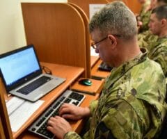 USMA man in uniform typing at computer
